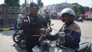 Satbrimob Polda Papua Pasang Dan Bagikan Bendera Merah Putih Ke Masyarakat