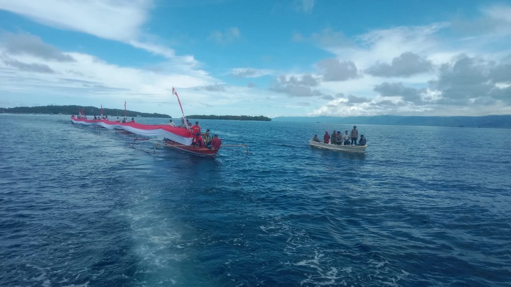 Sinergitas Polri dan Masyarakat: Pembentangan Bendera Merah Putih Raksasa di Laut Teluk Doreri dan Teluk Sawaibu Manokwari